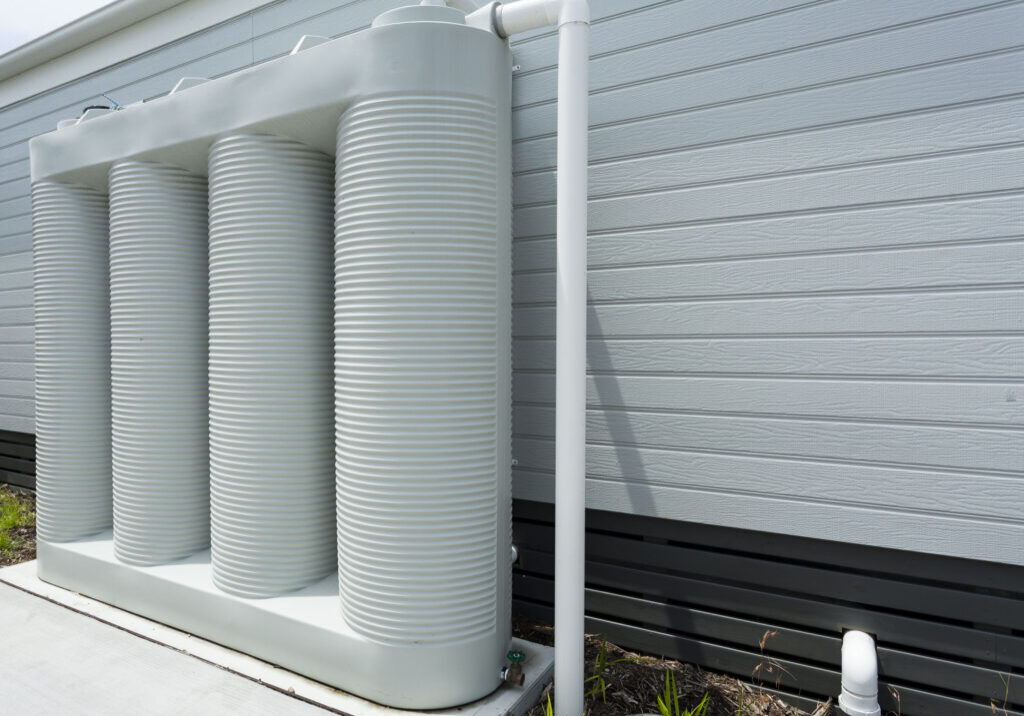 Rainwater tank Rainwater collection tank besides a modern house